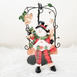Christmas holiday decor snowman on a swing